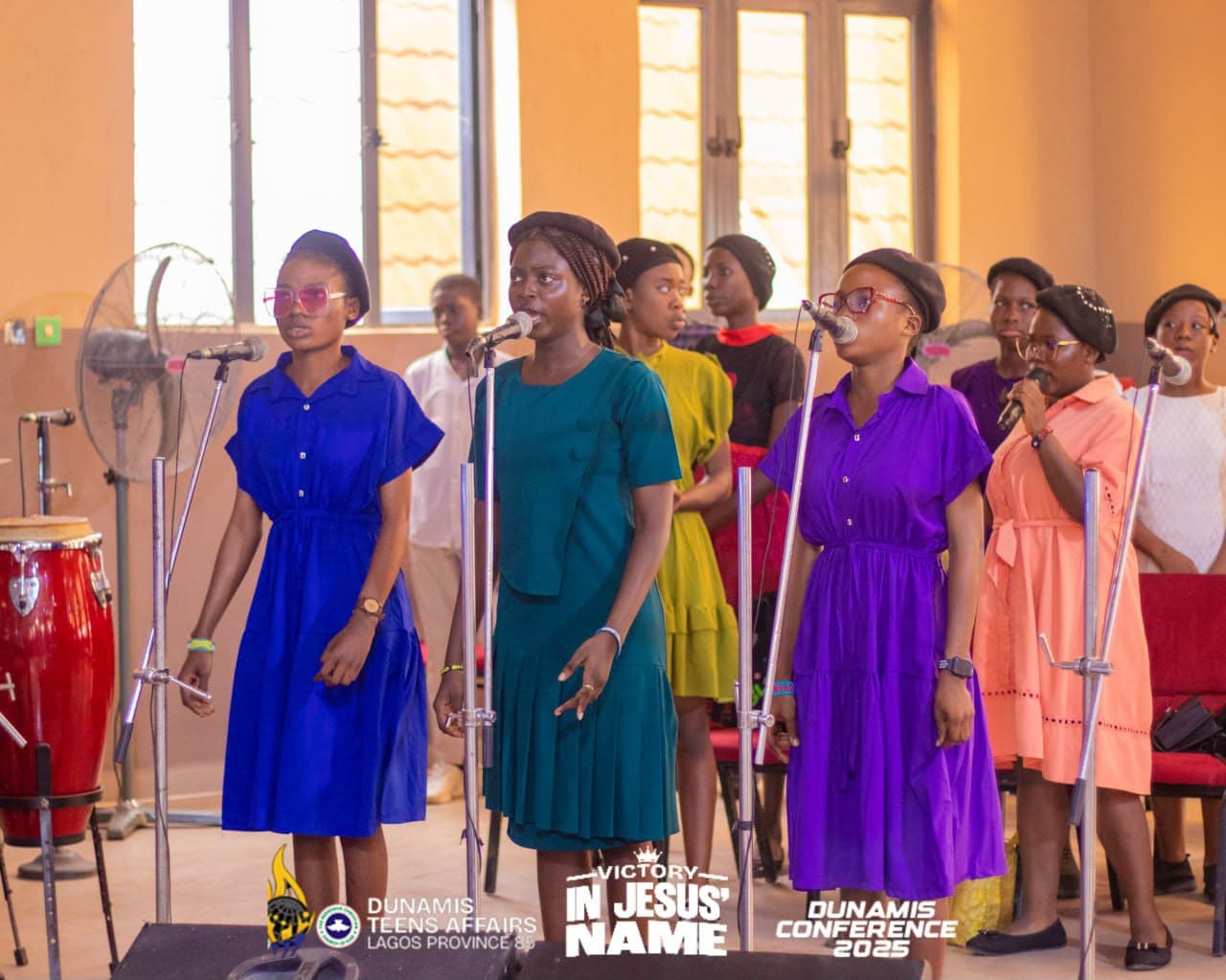 The teens choir leading worship on the microphones