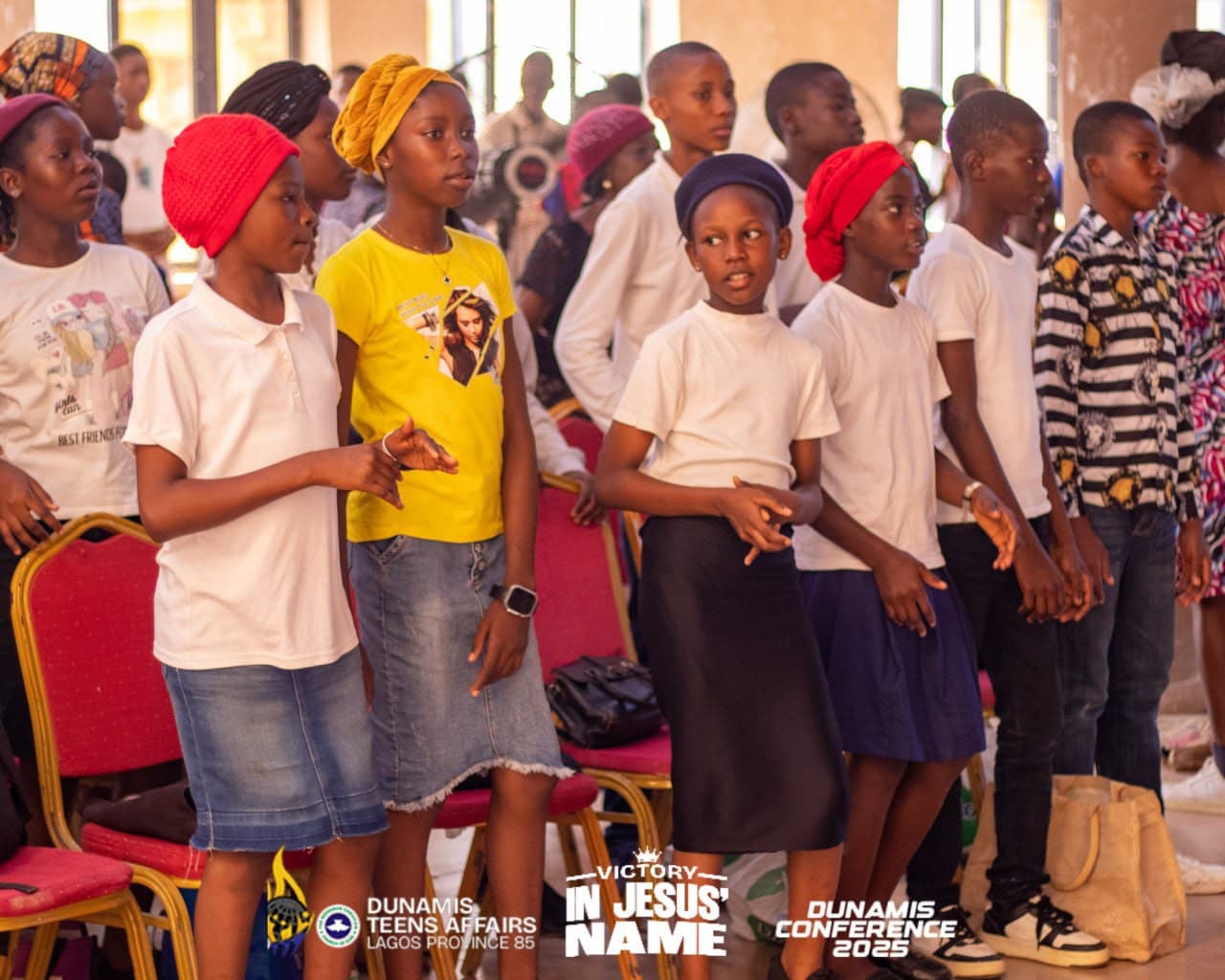 Rows of teenagers standing at the front of the hall